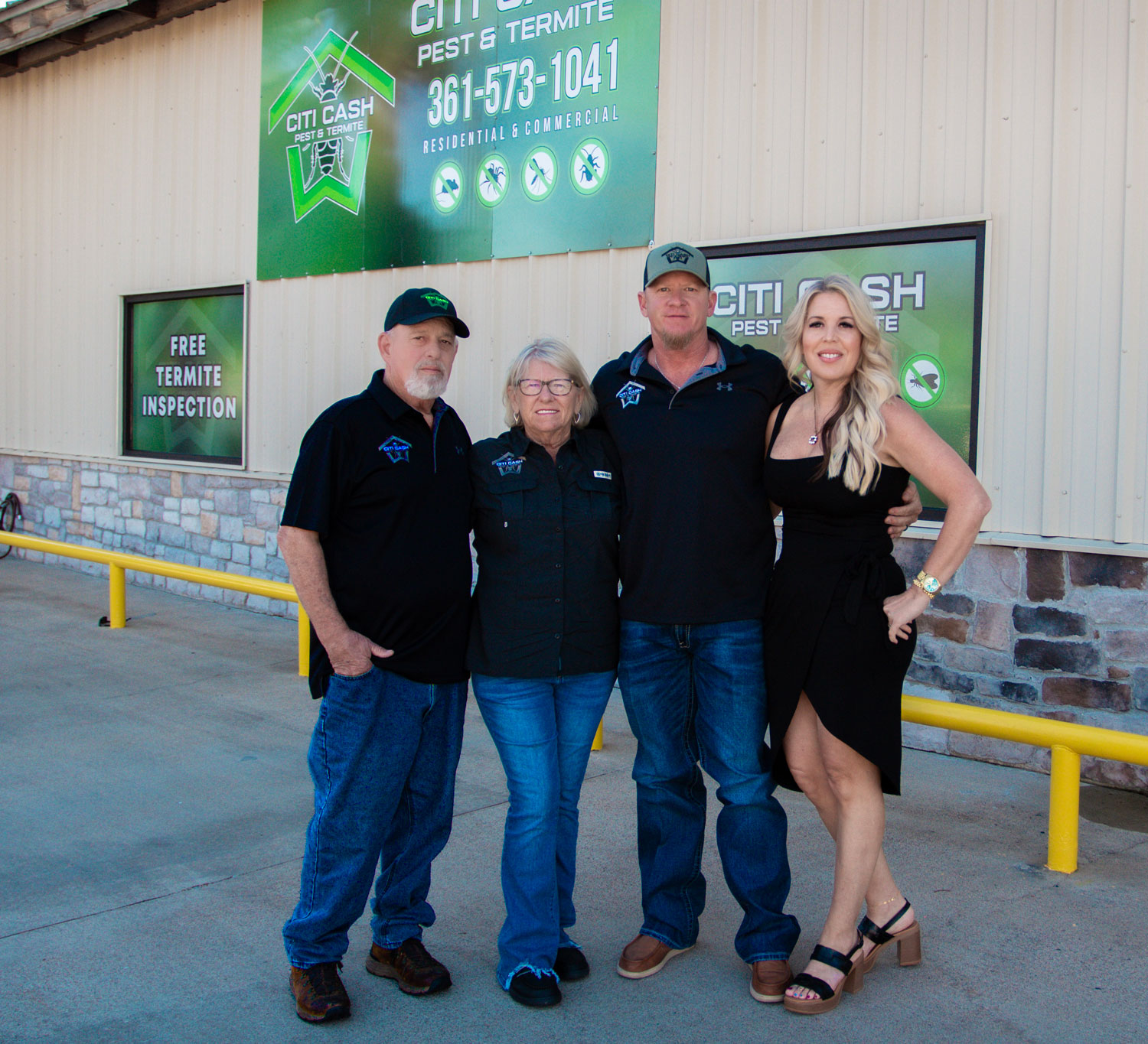 Four people standing and smiling in front of a pest control business building with a Citi Cash Pest & Termite sign.